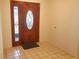 Welcoming foyer with a wooden door featuring decorative glass and tile flooring at 50 Water Oak Way, Oldsmar, FL 34677