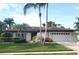 Charming single-Gathering home with a well-manicured lawn, mature palm trees, and an attached two-car garage at 50 Water Oak Way, Oldsmar, FL 34677