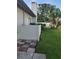 This home features a backyard with a privacy fence, lush lawn and landscaping with palms and green shrubbery at 50 Water Oak Way, Oldsmar, FL 34677