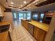 Open kitchen featuring wood cabinets, tile floors, and stainless steel dishwasher at 50 Water Oak Way, Oldsmar, FL 34677