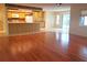 Open-concept kitchen featuring wood floors and bright cabinets at 50 Water Oak Way, Oldsmar, FL 34677