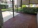Enclosed lanai boasts tile flooring and a view of the lush, fenced backyard at 50 Water Oak Way, Oldsmar, FL 34677