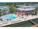 Aerial view showcases community pool, waterfront condos, and boat docks at 5042 Coquina Key Se Dr, St Petersburg, FL 33705