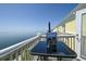 View of the ocean from the balcony featuring chairs and table at 5042 Coquina Key Se Dr, St Petersburg, FL 33705