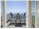 Balcony view of the ocean furnished with a table and chairs for outdoor relaxation at 5042 Coquina Key Se Dr, St Petersburg, FL 33705