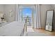 Bedroom featuring patio doors leading to a balcony with water views, and a full length mirror at 5042 Coquina Key Se Dr, St Petersburg, FL 33705
