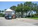 Gated community entrance with a guard house and a golf cart, offering security and convenience at 5042 Coquina Key Se Dr, St Petersburg, FL 33705