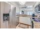 Well-maintained kitchen boasts granite counters, stainless appliances, and a view into the living room at 5042 Coquina Key Se Dr, St Petersburg, FL 33705