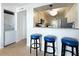 Bright kitchen area with breakfast bar, granite countertop, laundry closet, and stainless steel appliances at 5042 Coquina Key Se Dr, St Petersburg, FL 33705