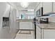 Well-lit kitchen boasts granite counters, stainless appliances, and a seamless flow into the living space at 5042 Coquina Key Se Dr, St Petersburg, FL 33705