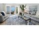 A cozy living room that offers access to the outdoor patio which provides amazing ocean views at 5042 Coquina Key Se Dr, St Petersburg, FL 33705