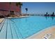Large outdoor swimming pool with lounge chairs and umbrellas, ideal for relaxation and recreation at 5042 Coquina Key Se Dr, St Petersburg, FL 33705
