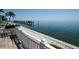Picturesque water view from patio featuring a long pier, calm waters, and serene atmosphere at 5042 Coquina Key Se Dr, St Petersburg, FL 33705