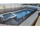 Backyard view of the private swimming pool and jacuzzi, secured by a safety fence and surrounded by patio pavers at 530 Severn Ave, Tampa, FL 33606