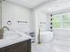 Luxurious bathroom featuring a freestanding tub, double vanity with elegant fixtures, and ample natural light at 5632 Indiana Ave, New Port Richey, FL 34652