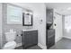 Charming bathroom featuring modern fixtures, elegant vanity, and stylish patterned wallpaper accent wall at 5632 Indiana Ave, New Port Richey, FL 34652