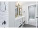 Modern bathroom with double sinks, decorative mirrors, and tiled shower at 5632 Indiana Ave, New Port Richey, FL 34652
