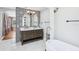 Elegant bathroom with double sinks, decorative tile wall, and modern fixtures at 5632 Indiana Ave, New Port Richey, FL 34652
