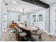 Spacious dining room with modern chandelier, long wooden table, and stylish decor at 5632 Indiana Ave, New Port Richey, FL 34652