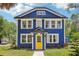 Charming blue two-story home with a bright yellow front door and white trim at 5632 Indiana Ave, New Port Richey, FL 34652