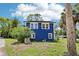 Charming blue home with lush landscaping and a well-maintained yard at 5632 Indiana Ave, New Port Richey, FL 34652