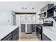 Modern kitchen with stainless appliances, white countertops, and dark cabinets at 5632 Indiana Ave, New Port Richey, FL 34652