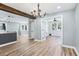 Spacious living room featuring hardwood floors and an elegant chandelier at 5632 Indiana Ave, New Port Richey, FL 34652