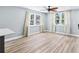 Bright living room with wood-look floors, neutral walls, and windows adorned with elegant, flowing curtains at 5632 Indiana Ave, New Port Richey, FL 34652