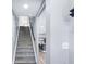 Carpeted staircase leading to the upper level with a view into the updated kitchen at 5632 Indiana Ave, New Port Richey, FL 34652
