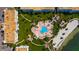 Aerial view of community pool, surrounded by condos and manicured grounds and steps from a sandy beach at 6021 Bahia Del Mar Cir # 239, St Petersburg, FL 33715