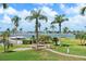 Backyard featuring a lush lawn, palm trees, a gazebo, and a view of the water, creating a relaxing tropical atmosphere at 6021 Bahia Del Mar Cir # 239, St Petersburg, FL 33715