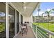 Balcony with patio furniture overlooking community green space and well-maintained landscaping at 6021 Bahia Del Mar Cir # 239, St Petersburg, FL 33715