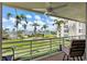 Balcony overlooking well-maintained green spaces, palm trees, and waterfront views at 6021 Bahia Del Mar Cir # 239, St Petersburg, FL 33715