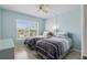 Comfortable bedroom featuring two twin beds, light wood flooring, and a window view at 6021 Bahia Del Mar Cir # 239, St Petersburg, FL 33715