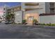 Condo building entrance showcasing well-maintained landscaping and ample parking spaces at 6021 Bahia Del Mar Cir # 239, St Petersburg, FL 33715