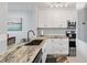 Stylish kitchen features stainless steel appliances, granite countertops, and modern white cabinets at 6021 Bahia Del Mar Cir # 239, St Petersburg, FL 33715