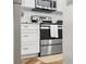 White kitchen cabinets, stainless steel appliances and herringbone floors create a stunning interior at 6021 Bahia Del Mar Cir # 239, St Petersburg, FL 33715