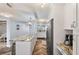 Open-concept kitchen featuring granite countertops, stainless steel appliances and herringbone floors at 6021 Bahia Del Mar Cir # 239, St Petersburg, FL 33715