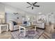 Spacious living room with plush seating, area rug, mirrored wall and access to kitchen at 6021 Bahia Del Mar Cir # 239, St Petersburg, FL 33715