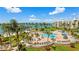 Community pool with palms and lounge area; bridge and building views beyond at 6021 Bahia Del Mar Cir # 239, St Petersburg, FL 33715
