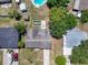Aerial view showcasing the property's layout, pool, and surrounding landscape, offering a unique perspective of the home's setting at 6208 Florida E Cir, Apollo Beach, FL 33572