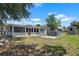 Expansive backyard with a screened patio, above-ground pool, offering a private outdoor space for relaxation and entertainment at 6208 Florida E Cir, Apollo Beach, FL 33572