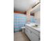 Bathroom with a sink and mirror, featuring a shower with a stylish curtain, providing a clean and refreshing experience at 6208 Florida E Cir, Apollo Beach, FL 33572