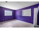 Empty purple bedroom with a white built-in shelf, and a window offering natural light, creating a serene and relaxing ambiance at 6208 Florida E Cir, Apollo Beach, FL 33572