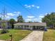 Charming single story home boasts a well-maintained lawn, mature landscaping and a covered carport at 6208 Florida E Cir, Apollo Beach, FL 33572