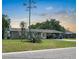 Charming single story home boasts a well-maintained lawn, mature landscaping and a covered carport at 6208 Florida E Cir, Apollo Beach, FL 33572