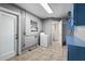 Spacious laundry room with washer, tiled floors and door to the backyard at 6208 Florida E Cir, Apollo Beach, FL 33572