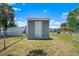 Backyard shed with a door, nestled in a grassy area, offering practical storage and functional utility on the property at 6208 Florida E Cir, Apollo Beach, FL 33572