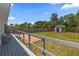 Fenced backyard view from wooden deck features storage shed, green lawn, and mature landscaping at 6235 17Th N Ave, St Petersburg, FL 33710