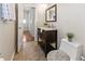 Well-lit bathroom features dark wood vanity, marble countertop, and decorative mirror at 6235 17Th N Ave, St Petersburg, FL 33710